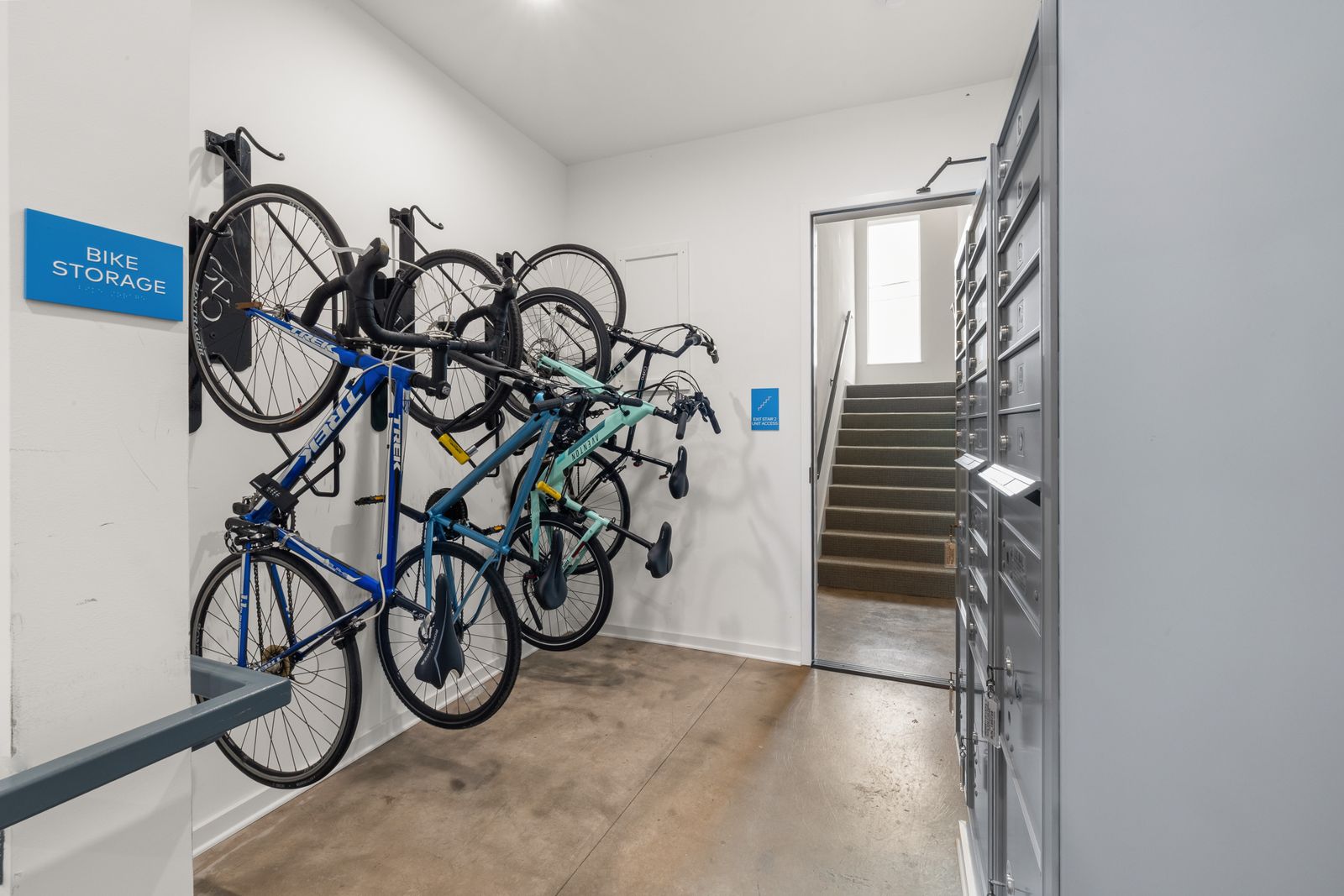 Garage Organization Ideas That Make Room for the Car Again 6 Bicycles mounted on wall racks in a dedicated bike storage area, photo by Curtis Adams via Pexels