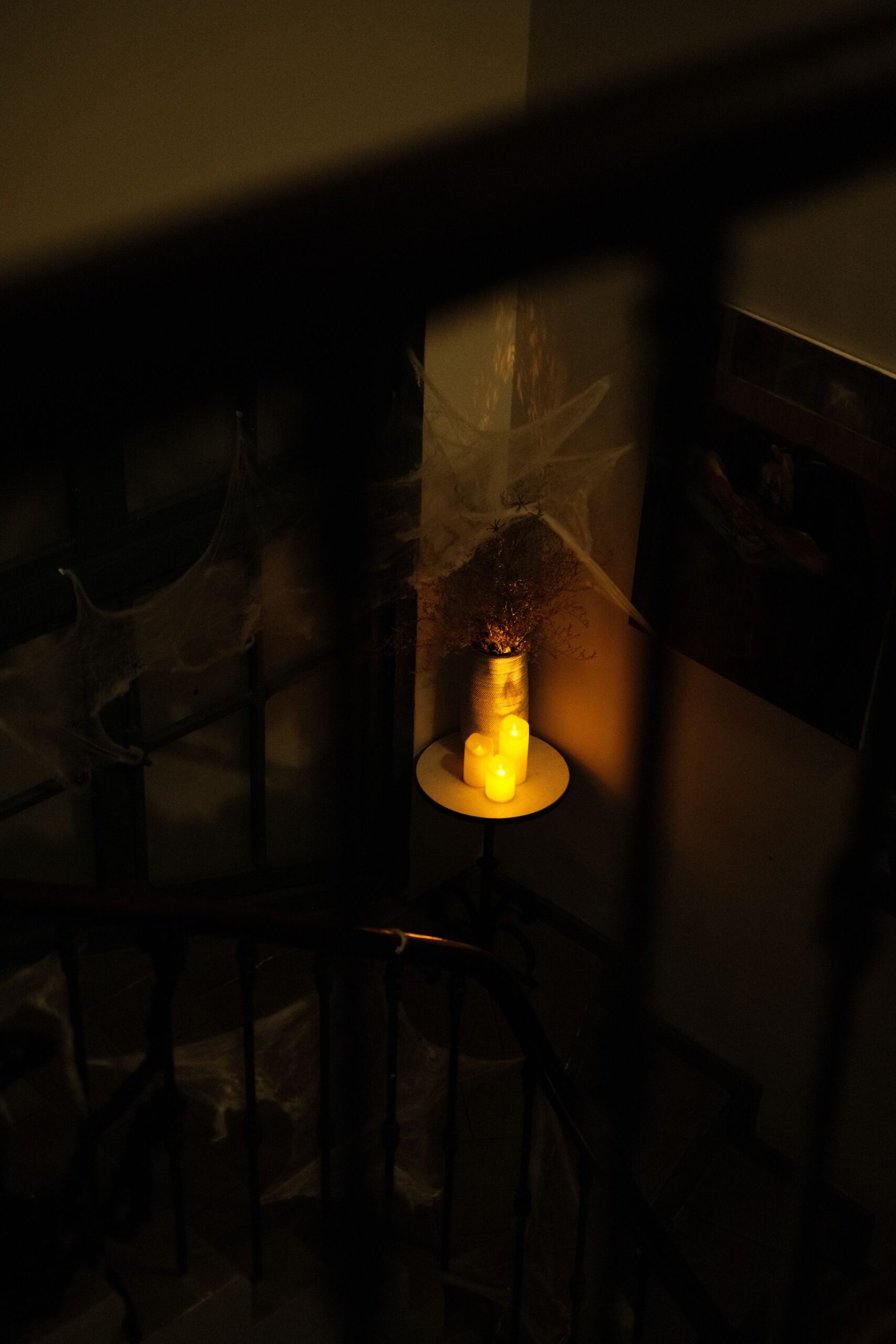 Elegant Halloween Decor Ideas for Every Room in Your Home 4 Staircase landing styled with candlelight and delicate cobwebs, photo by Pew Nguyen via Pexels