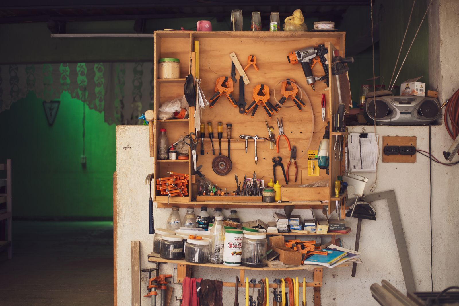 Garage Organization Ideas That Make Room for the Car Again 7 Small organized workbench with a tool pegboard and supplies in a home workshop, photo by Noemí Jiménez via Pexels
