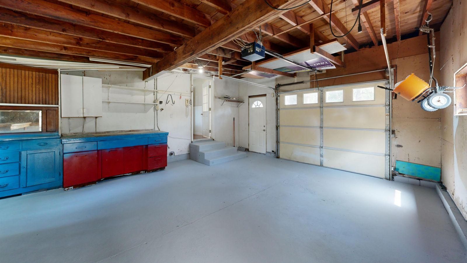 Garage Organization Ideas That Make Room for the Car Again 2 Empty garage with open space and colorful storage cabinets along the wall, photo by Peter Vang via Pexels